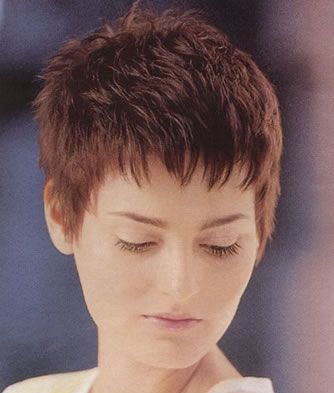 A teen with her eyes closed and nice short haircut