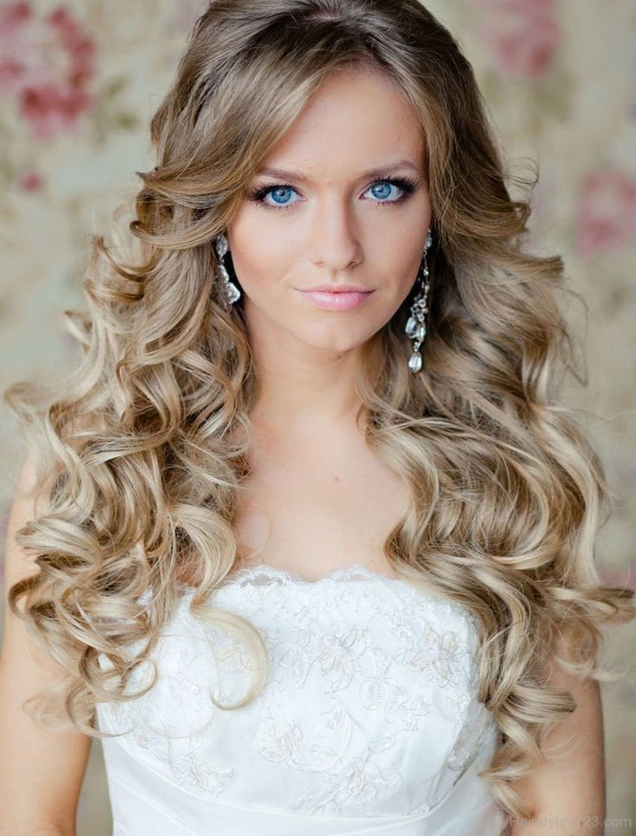 Woman with long curly hairstyle with short bangs